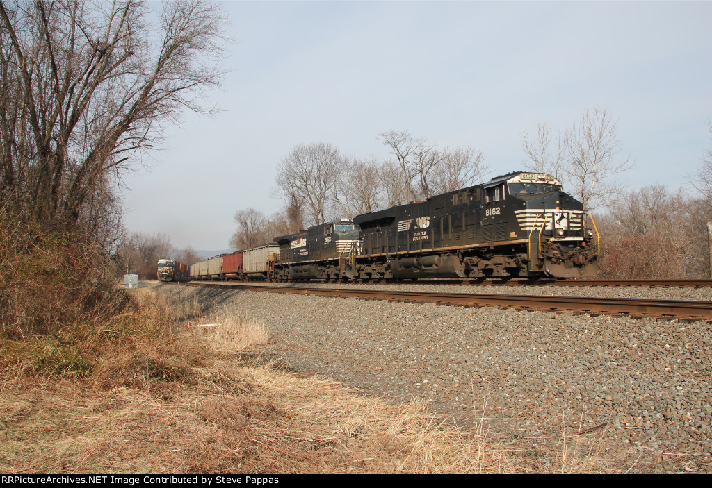 NS 8162 takes train 590 east past MP116